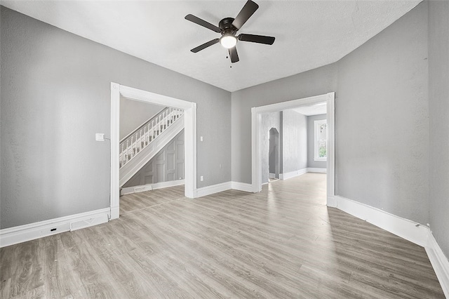 unfurnished living room featuring light hardwood / wood-style flooring and ceiling fan