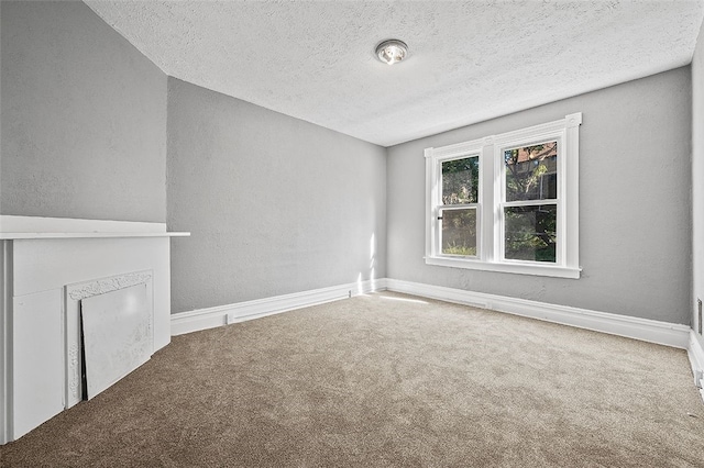 unfurnished living room featuring carpet floors, a textured ceiling, and a fireplace