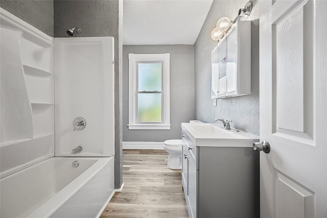 full bathroom featuring hardwood / wood-style floors, vanity, toilet, and bathtub / shower combination