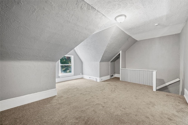 additional living space featuring light carpet, a textured ceiling, and lofted ceiling