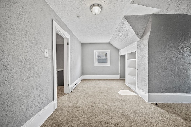 walk in closet featuring carpet floors and lofted ceiling