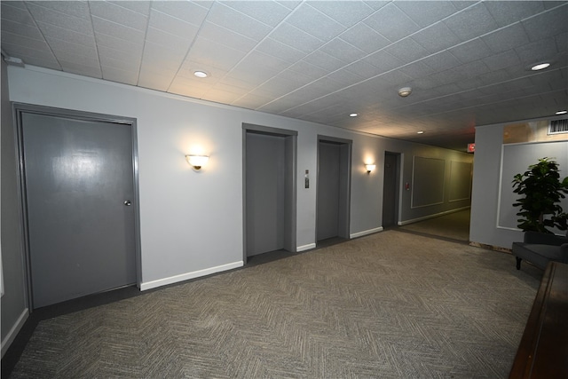 carpeted empty room with elevator