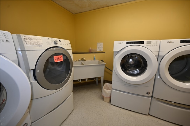 laundry area featuring washer and clothes dryer and sink