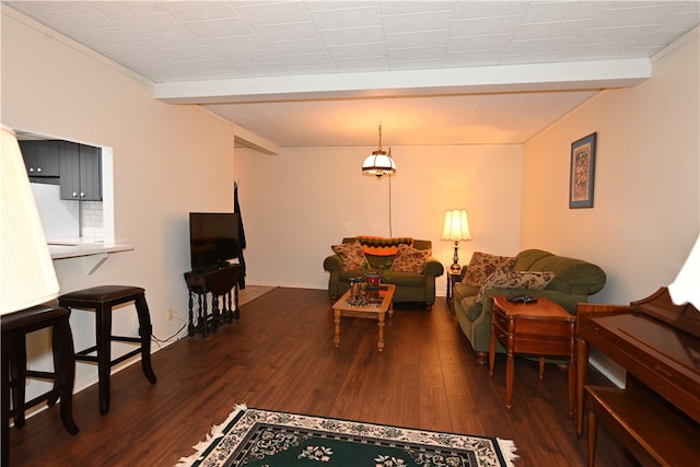 living room featuring beam ceiling and dark hardwood / wood-style flooring