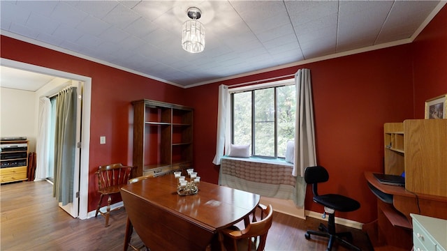 dining room with wood-type flooring and ornamental molding