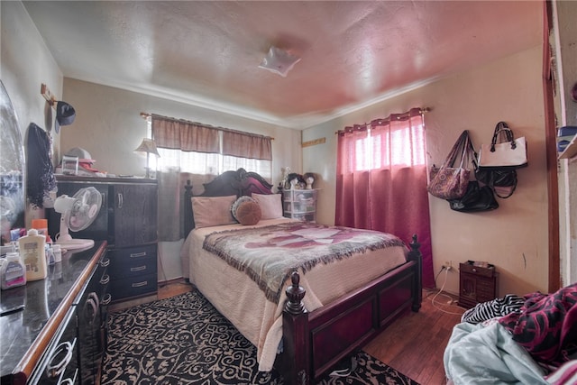 bedroom with dark wood-type flooring