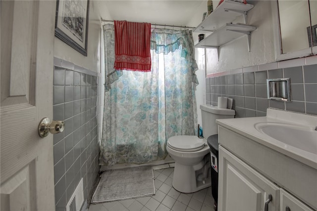 bathroom with vanity, tile walls, and toilet