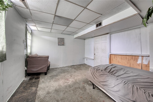 bedroom with carpet flooring and a paneled ceiling