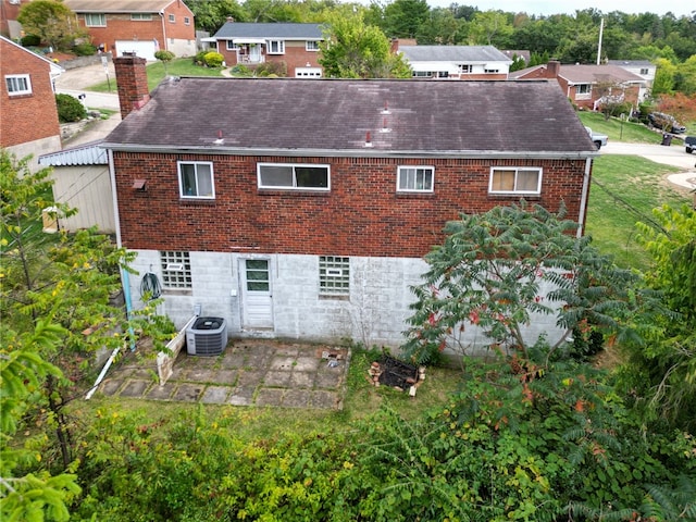 back of property with cooling unit and a patio area