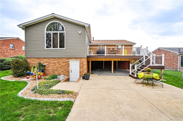 back of house with a patio area, a deck, and a yard