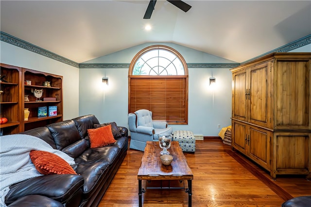 living room featuring vaulted ceiling, ceiling fan, and hardwood / wood-style flooring