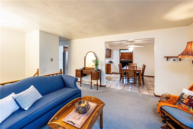 living room with ceiling fan and light tile patterned floors