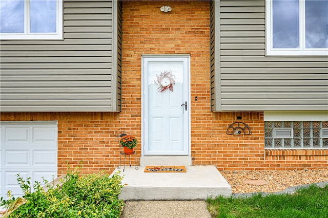 doorway to property with a garage