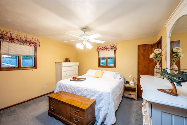 bedroom with ceiling fan and dark carpet