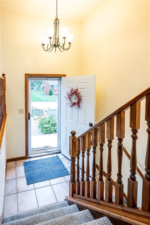 tiled entrance foyer featuring a chandelier