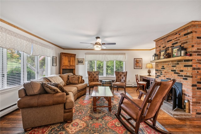 living room featuring ceiling fan, a fireplace, crown molding, and dark wood-type flooring