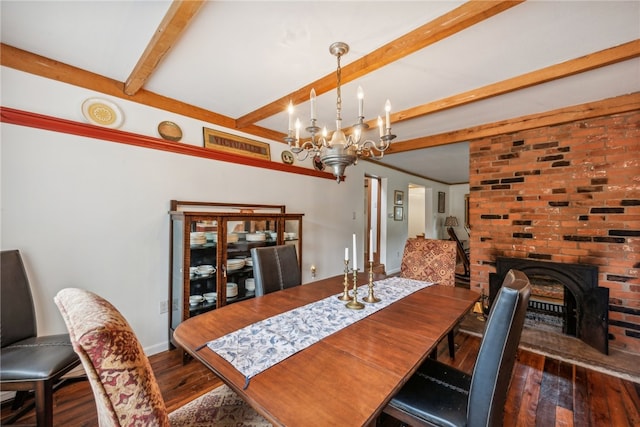 dining area with a fireplace, beam ceiling, a chandelier, and dark hardwood / wood-style floors