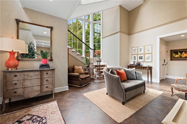 living room with dark parquet floors and high vaulted ceiling