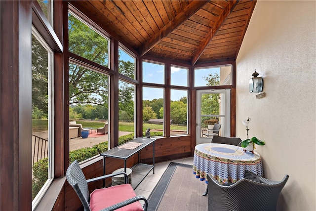 sunroom / solarium with wooden ceiling, vaulted ceiling with beams, and a wealth of natural light