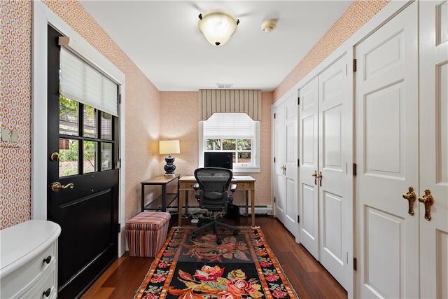 home office with baseboard heating, plenty of natural light, and dark hardwood / wood-style flooring