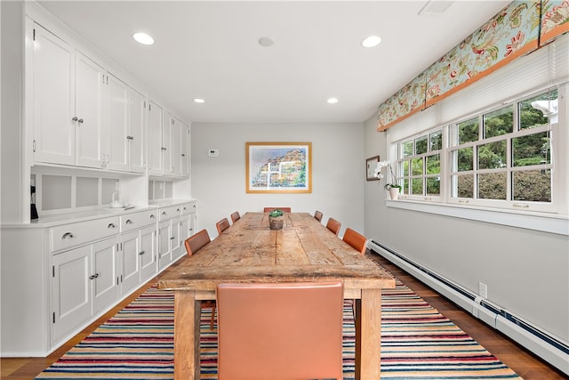 interior space with dark hardwood / wood-style floors and a baseboard heating unit