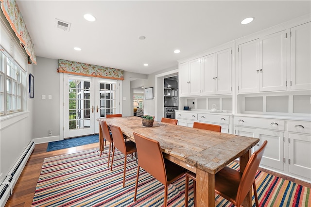 dining space featuring french doors, baseboard heating, and dark hardwood / wood-style flooring