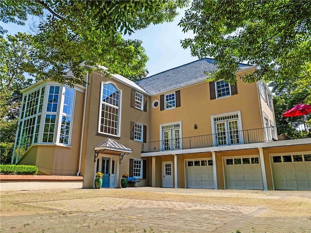 exterior space with a balcony and a garage