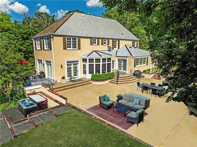 rear view of property with french doors, outdoor lounge area, a yard, and a patio