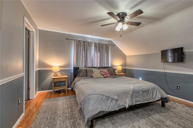 bedroom featuring wood-type flooring, lofted ceiling, and ceiling fan