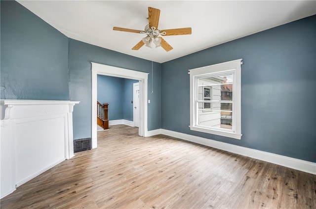 unfurnished room with light wood-type flooring and ceiling fan