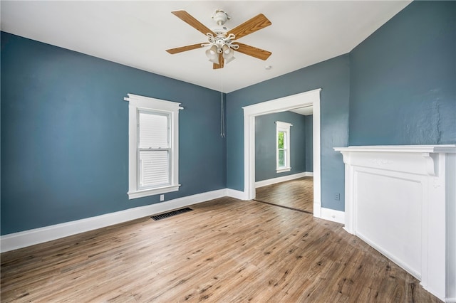 unfurnished room with ceiling fan and hardwood / wood-style floors