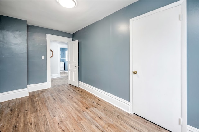 spare room with light hardwood / wood-style flooring