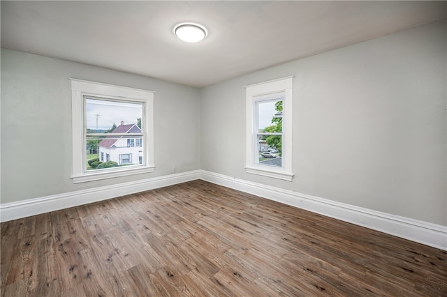 unfurnished room with wood-type flooring