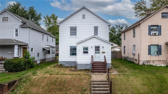 rear view of property with a yard