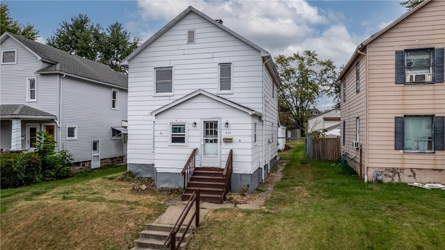 back of house featuring a yard