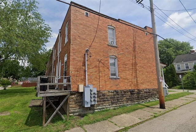 view of home's exterior with a yard and brick siding