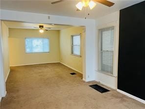 unfurnished room with ceiling fan, carpet floors, and a healthy amount of sunlight