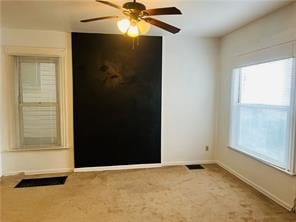 carpeted empty room with ceiling fan