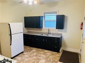 kitchen with sink, ceiling fan, and white refrigerator