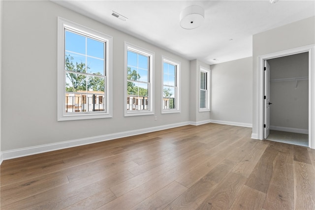 unfurnished bedroom featuring light wood-type flooring and a closet