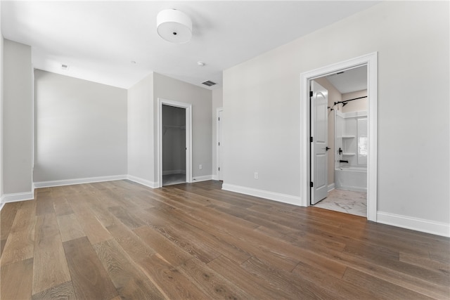 spare room featuring hardwood / wood-style flooring and a barn door