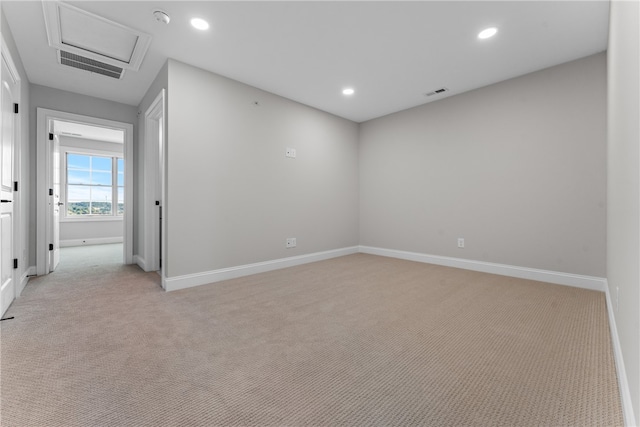 unfurnished room featuring light colored carpet