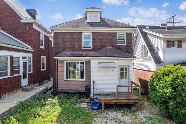 rear view of house featuring a wooden deck