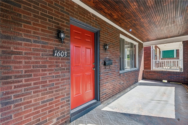 view of exterior entry featuring a porch