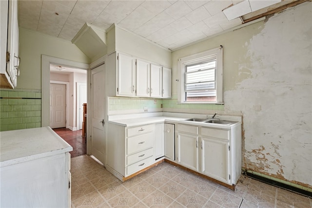 kitchen featuring white cabinetry and sink