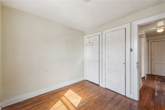 unfurnished bedroom featuring dark wood-type flooring