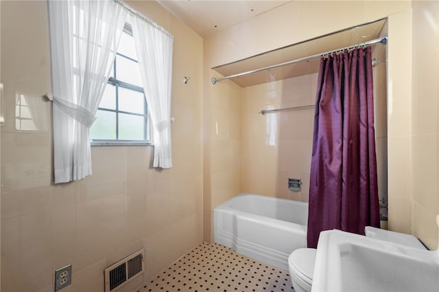 bathroom featuring shower / bath combo and toilet