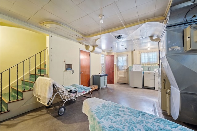 interior space featuring concrete flooring and washing machine and dryer