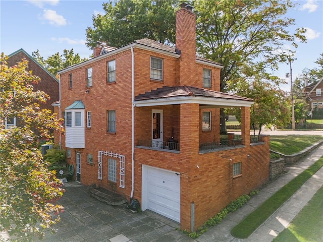 exterior space with central AC and a garage