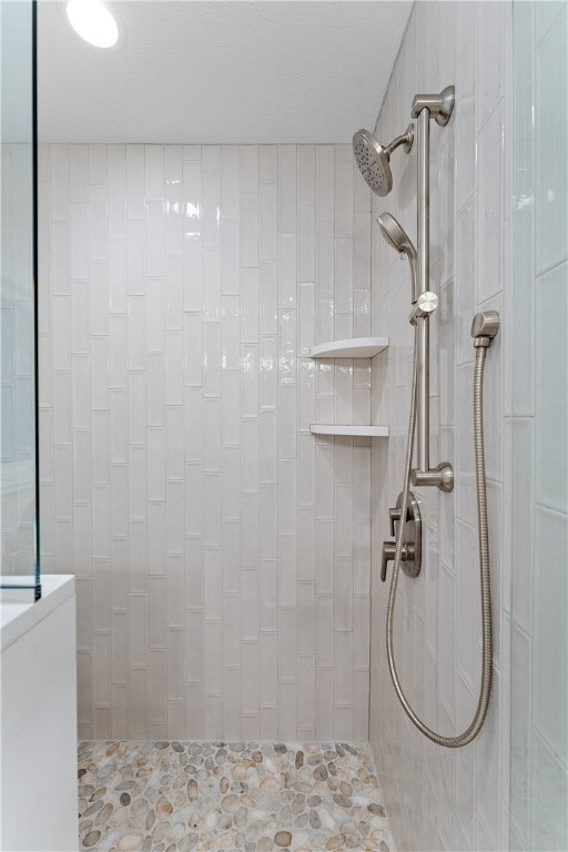 bathroom with tiled shower